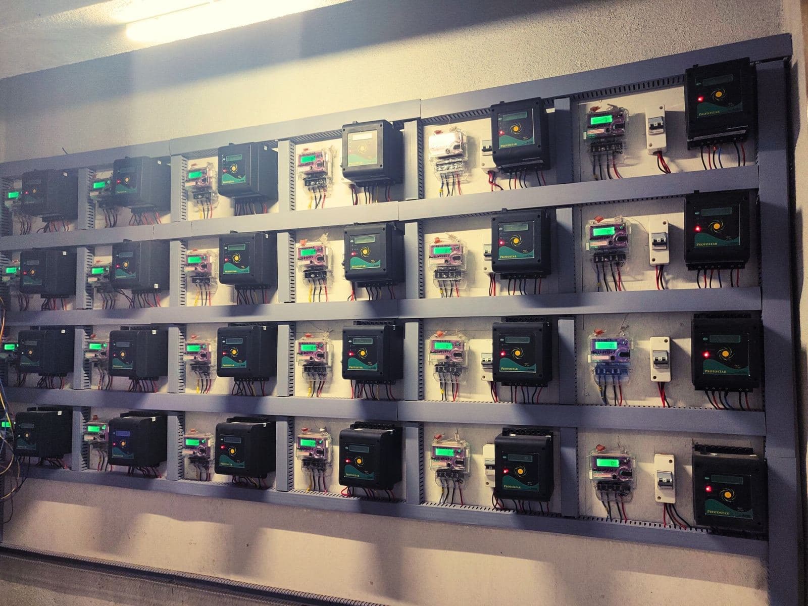 Bank of SPDU meters in a building meter room distributing solar to each flat