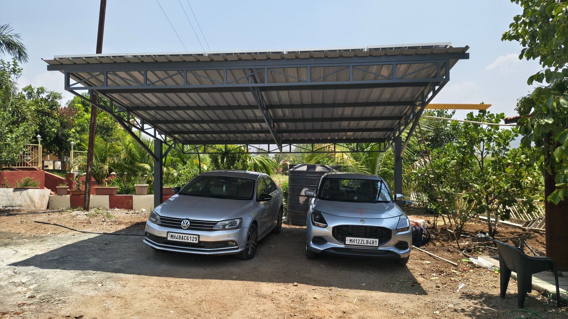 Cars parked under a solar carport structure